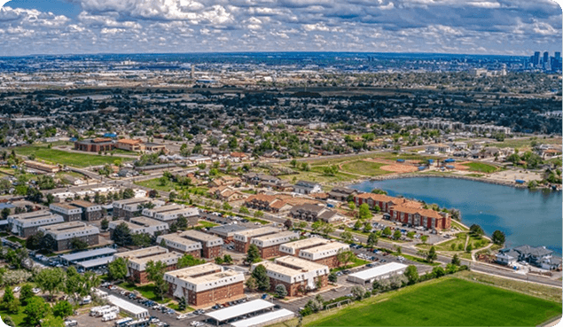 an aerial view of buildings and a lake
