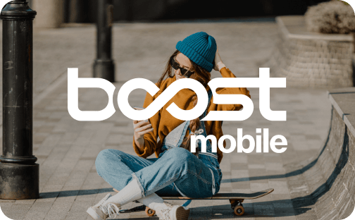 A young woman in a blue beanie and sunglasses sitting on a skateboard, using her phone. The Boost Mobile logo is overlaid.