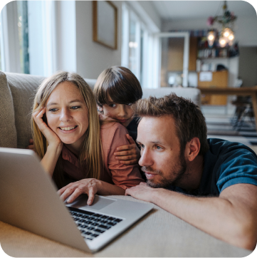 Family scrolling on a laptop.
