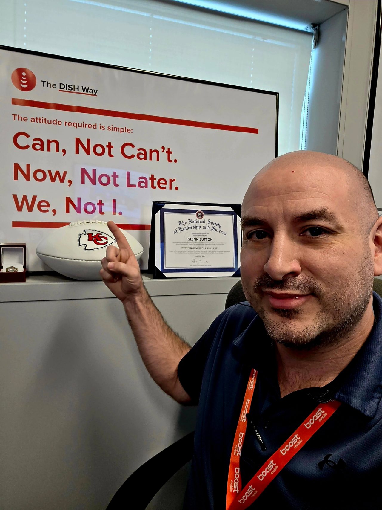Image of Glenn Sutton next to a poster of "The DISH Way"
