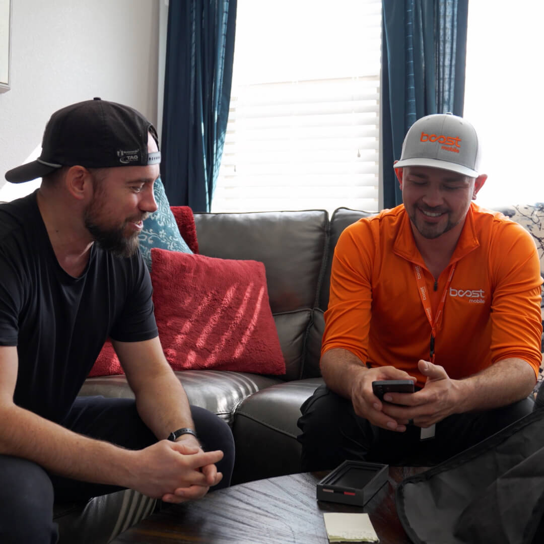 Boost Mobile technician helping a customer activate their phone