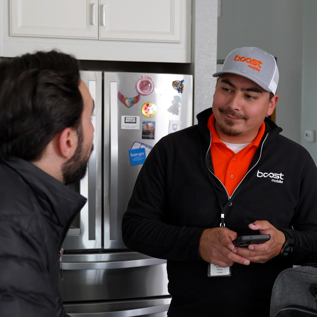 Boost Mobile technician helping a customer activate their phone
