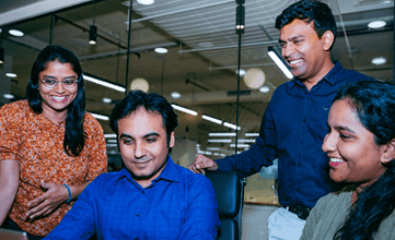 A group of four coworkers chatting amicably 