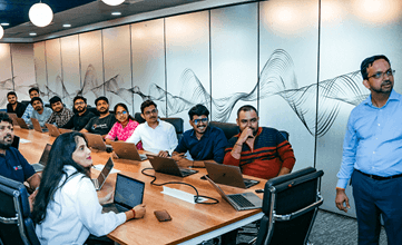 A man leading a presentation to many individuals